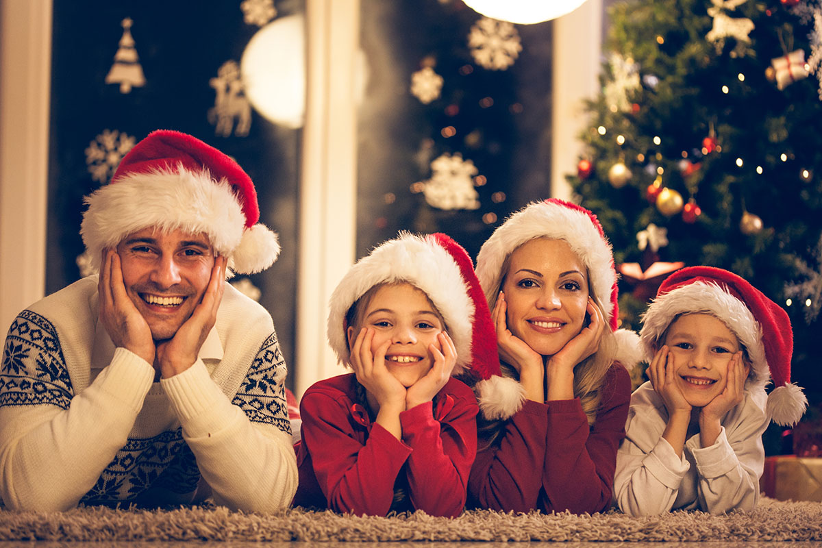 Portrait of a family wearing Christmas hats