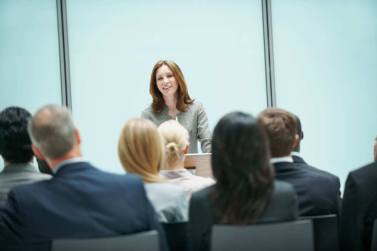 Beautiful business woman presenting during a conference